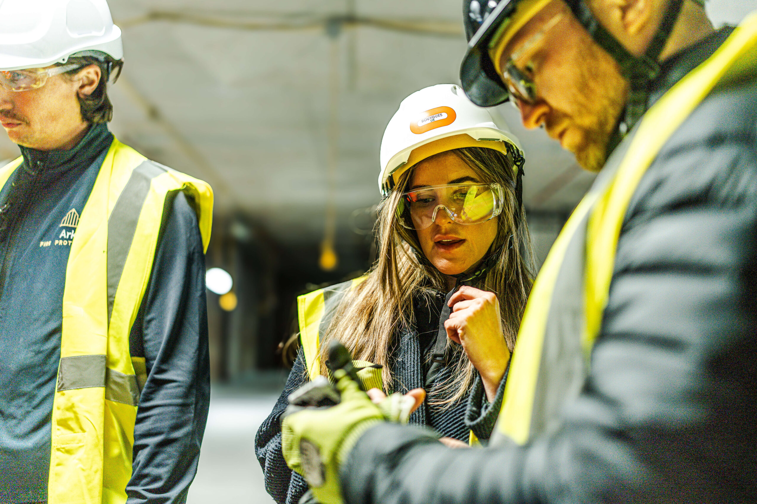 Female Ark team member in high hat and safety equipment.